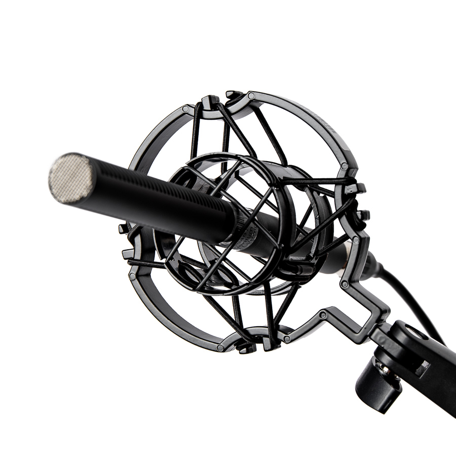 Schwarzes Richtrohrmikrofon in einer Mikrofonspinne mit elastischer Aufhängung und Halterung an einem Mikrofonarm.